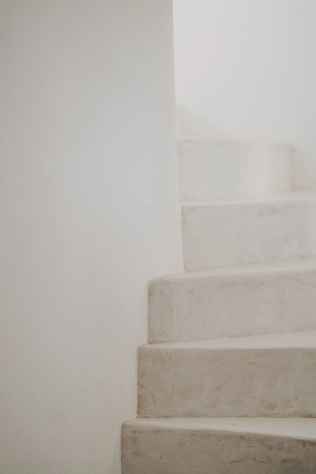 Pale stone steps beside a white wall